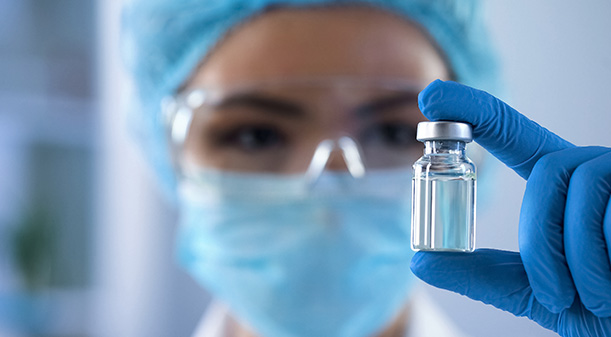 glass vials filled with liquid on production line with medical equipment 4 vaccine manufacturing process
